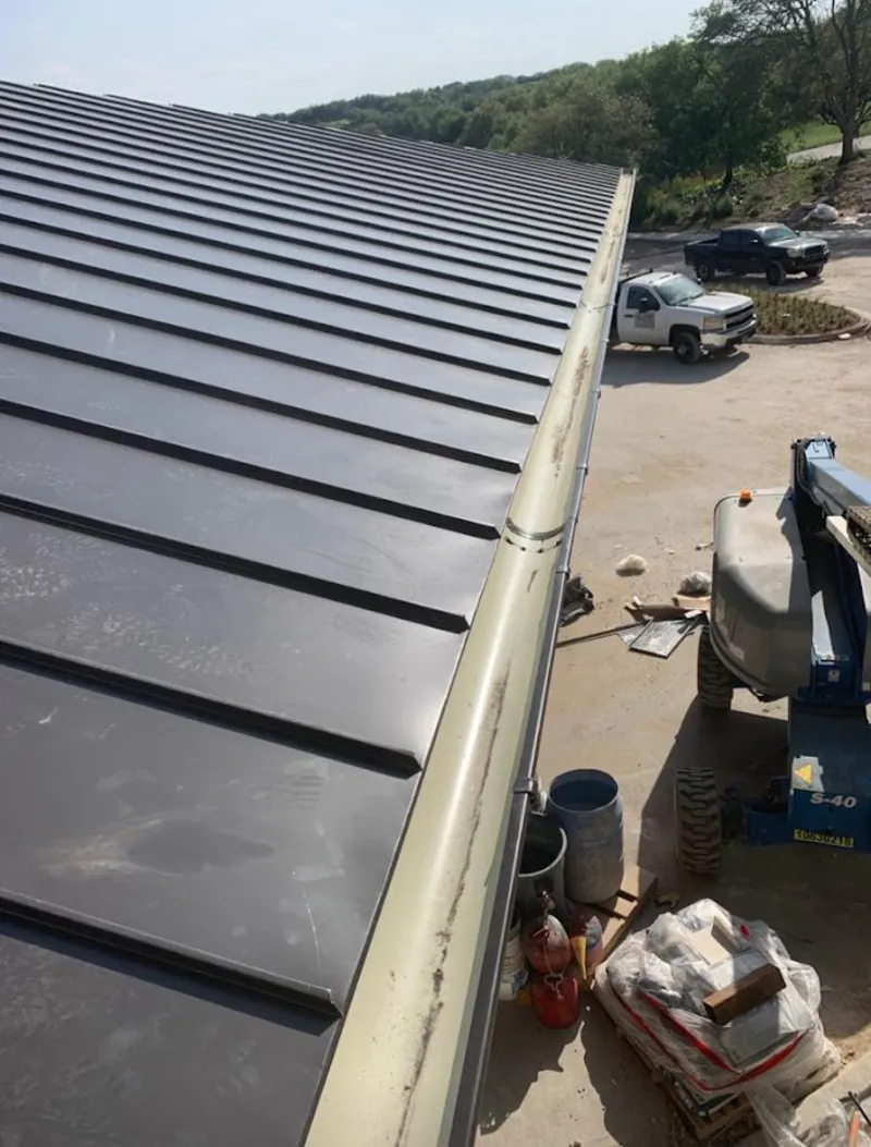 Standing seam panel and gutter detail on a metal roofing jobsite in Fairborn